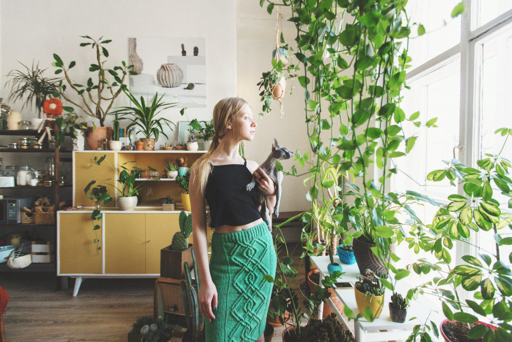 woman with plants in her house