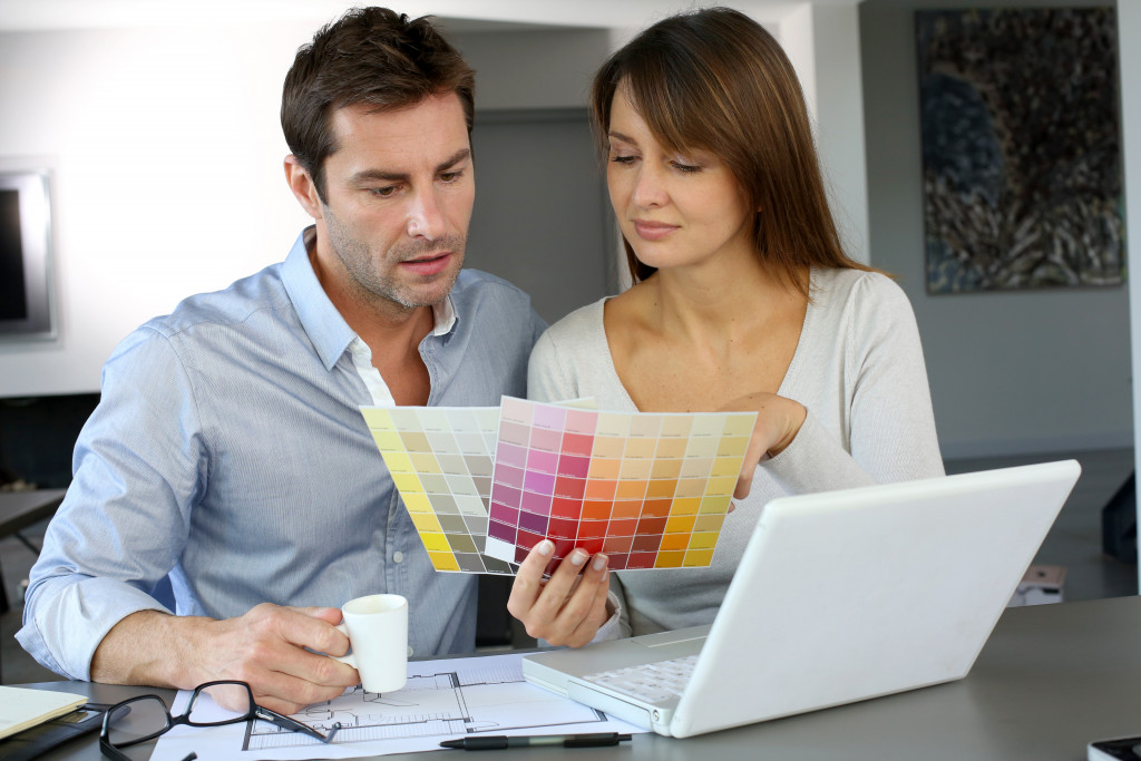 couple picking which color palette will they use on their home renovations